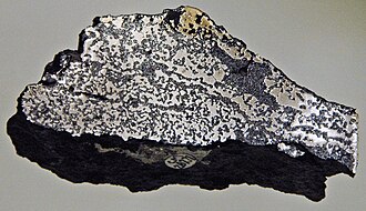 A sample of Siberian Traps basalt (dark) containing native iron (from the Putorana Plateau)