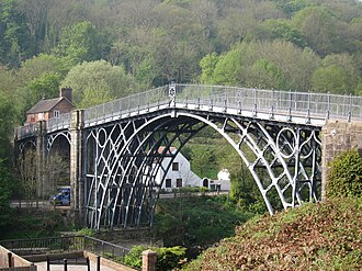 The application of the steam engine allowed coke to be substituted for charcoal in iron making, lowering the cost of iron, which provided engineers with a new material for building bridges. This bridge was made of cast iron, which was soon displaced by less brittle wrought iron as a structural material.