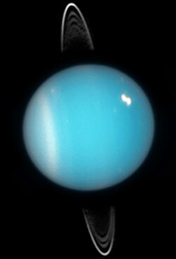 Uranus in 2005. Rings, southern collar and a bright cloud in the northern hemisphere are visible (HST ACS image).