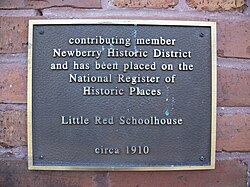 Plaque acknowledging Little Red Schoolhouse as a contributing property to Newberry Historic District in Newberry, Florida
