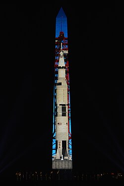 A Saturn V rocket projected onto the Washington Monument during the Apollo 11 50th anniversary show