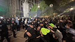 NYPD officers clear a crowd by force from Columbia's gates on Amsterdam Avenue.[194]