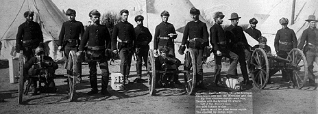 Soldiers pose with three of the four Hotchkiss-designed M1875 mountain guns used at Wounded Knee.[b]