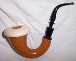 Calabash pipe with meerschaum bowl. This particular example was made in the US by the Pioneer pipe company. First appearing in the late 1960s, these were sold as a cheaper alternative to European-made calabashes.[citation needed] The Vulcanite joiner and fussy bit are distinctive signs of the company's manufacture.[citation needed]