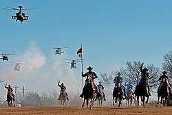 The 1st Cavalry Division's combat aviation brigade performing a mock charge with the horse detachment