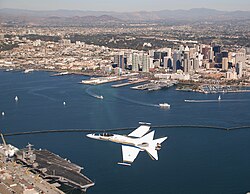 An F/A-18 Hornet flying over San Diego. The city serves as a major hub for the defense industry and U.S. military.