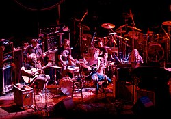 An acoustic performance at the Warfield Theatre in San Francisco in 1980. Left to right: Garcia, Lesh, Kreutzmann, Weir, Hart, Mydland.
