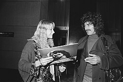 Harrison leaving the Hilton Hotel in Amsterdam, and signing an album for a fan, February 1977