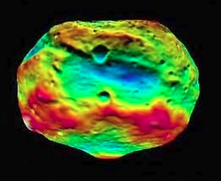 Feralia Planitia, an old, degraded impact basin or impact basin complex near Vesta's equator (green and blue). It is 270 km (168 mi) across and predates Rheasilvia (green at bottom)