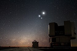 In the night sky over ESO's Very Large Telescope (VLT) observatory at Paranal, the Moon shines along with two bright companions: Venus and Jupiter.