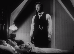 Robert Mitchum playing Preacher Harry Powell and Shelley Winters as Willa Harper