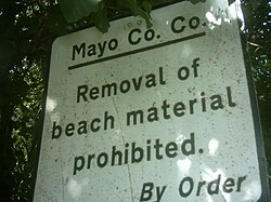 Sign in County Mayo, Ireland, forbidding the removal of sand and stones from a beach.