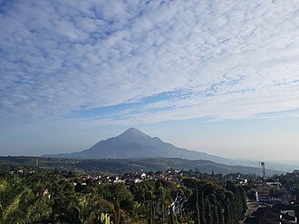 Mount Pawitra (Penanggungan) in East Java, surrounded by symmetric hills, believed as the top part of the mythical Mount Meru mentioned in Tantu Pagelaran