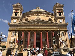 The Basilica of the Assumption of Our Lady, also known as Mosta Dome or as Mosta Rotunda, in Mosta, Malta. The façade is decorated for the Feast of the Assumption on 15 August.