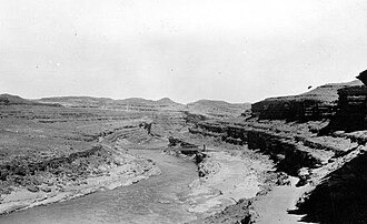 Several stages of downcutting by the San Juan River in Utah can be identified in this 1927 photo. Remnants of former floodplains stand as terraces above the river's modern level.