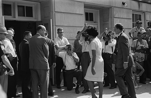 African American university student Vivian Malone entering the University of Alabama in the US to register for classes as one of the first African American students to attend the institution. Until 1963, the university was racially segregated and African American students were not allowed to attend.