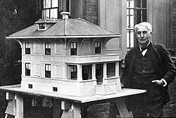 Edison with a model of a concrete house