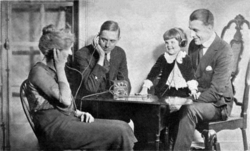 A family listening to a crystal radio in the 1920s