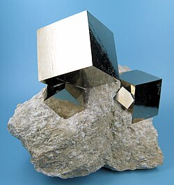 Pyrite cubic crystals on marl from Navajún, La Rioja, Spain (size: 95 by 78 millimetres [3.7 by 3.1 in], 512 grams [18.1 oz]; main crystal: 31 millimetres [1.2 in] on edge)