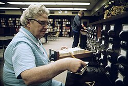Librarian at the card files at a senior high school in New Ulm, Minnesota (1974)