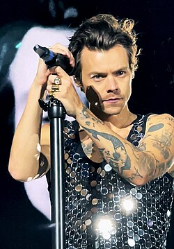 Harry Styles with a microphone
