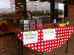 A girl selling Girl Scout Cookies