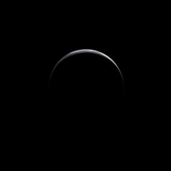 Departing image of Triton, showing its hazy atmosphere illuminated by sunlight and "extending" its crescent