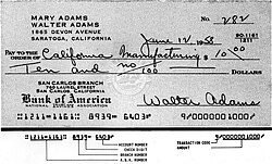 An early demonstration of use of an E-13 MICR font on a cheque. The "transit" glyph differs from E-13B.
