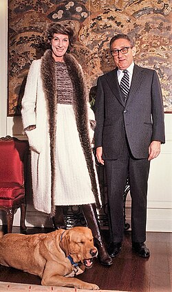 Nancy and Henry Kissinger in their New York City apartment with their dog Tyler, 1978
