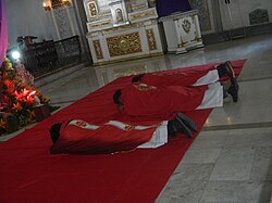 At the start of a Good Friday service, the priest and deacon (if any) lie flat on the floor as a sign of humility, grief and sorrow at the sacrifice of Christ on the cross.