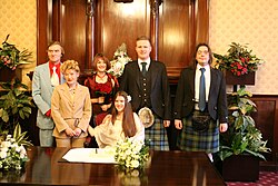 The groom and one other in the wedding party wear a kilt with Argyll jacket and long tie.