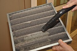 A dirty air filter being cleaned