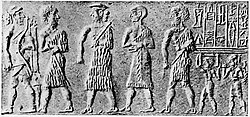 Cylinder seal of the scribe Kalki, showing Prince Ubil-Eshtar, probable brother of Sargon, with dignitaries (an archer in front, two dignitaries, and the scribe holding a tablet following the Prince). Inscription: "Ūbil-Aštar, brother of the king: KAL-KI the scribe, (is) his servant."[10][55]