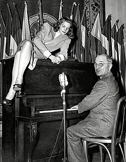 20-year-old Bacall lounges on top of the piano while Vice President Harry S. Truman plays for servicemen at the National Press Club Canteen in Washington, D.C. (February 10, 1945)