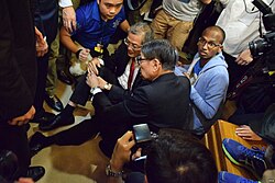 Lo Chung-mau on the ground, clutching his knee