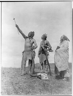 The Oath Apsaroke by Edward S. Curtis depicting Crow men giving a symbolic oath with a bison meat offering on an arrow