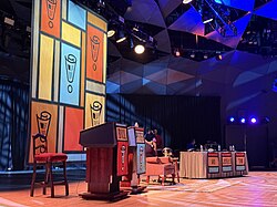 Announcer podiums (left), celebrity guest chair (center) and panelist table (right)