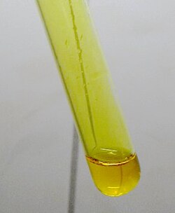 Yellow chlorine dioxide (ClO2) gas above a solution of hydrochloric acid and sodium chlorite in water, also containing dissolved chlorine dioxide