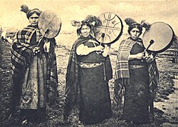 Three machis, each with a kultrun drum, photographed in 1900