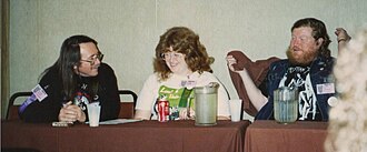 Fantasy writers on a panel at the World Fantasy Conference in Seattle, Washington, in 1989. From left to right: Ed Bryant, Nancy A. Collins, and Karl Edward Wagner.