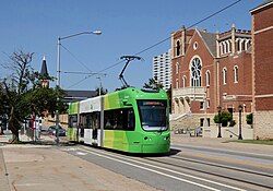 Streetcar of the OKC Streetcar system passing the historic First United Methodist Church, in downtown