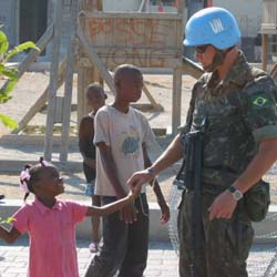 Brazilian MINUSTAH soldier with a Haitian girl in February 2005