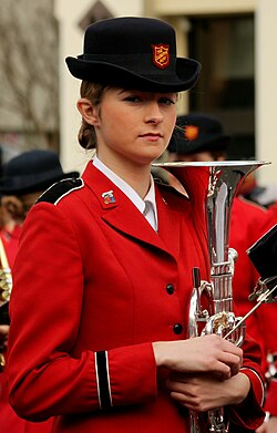 A woman preparing to march with The Salvation Army band, holding an E-flat Tenor horn, 2013