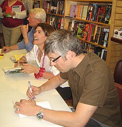 Regular Wait Wait... panelists (l–r) Roy Blount Jr., Amy Dickinson, and Mo Rocca sign autographs following a 2010 taping in New Orleans.