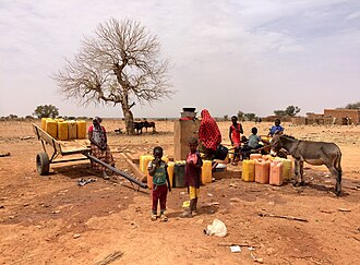 Families collecting water from a water well in Niger.