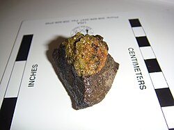 Olivine weathering to iddingsite within a mantle xenolith, demonstrating the principles of the Goldich dissolution series
