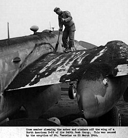 Ash being swept off a wing of an American B-25 Mitchell medium bomber of the 340th Bombardment Group on 23 March 1944 after the eruption of Mount Vesuvius