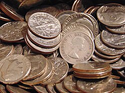 Copper alloys are widely used in the production of coinage; seen here are two examples – post-1964 American dimes, which are composed of the alloy cupronickel[68] and a pre-1968 Canadian dime, which is composed of an alloy of 80 percent silver and 20 percent copper.[69]