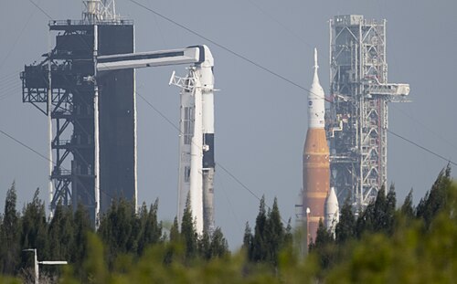 A juxtaposition of private (left) and public (right) spaceflight. From Kennedy Space Center LC-39, taken on April 6, 2022.Left: SpaceX, with Falcon 9 for Axiom Mission 1Right: NASA, with Space Launch System for Artemis 1