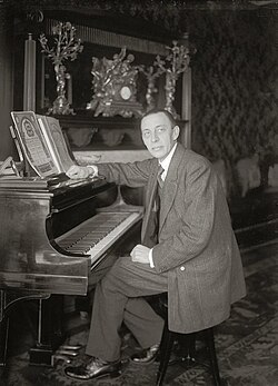 Rachmaninoff seated at a Steinway grand piano